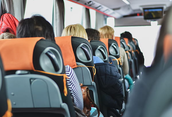 interior of a modern charter bus with seated passengers